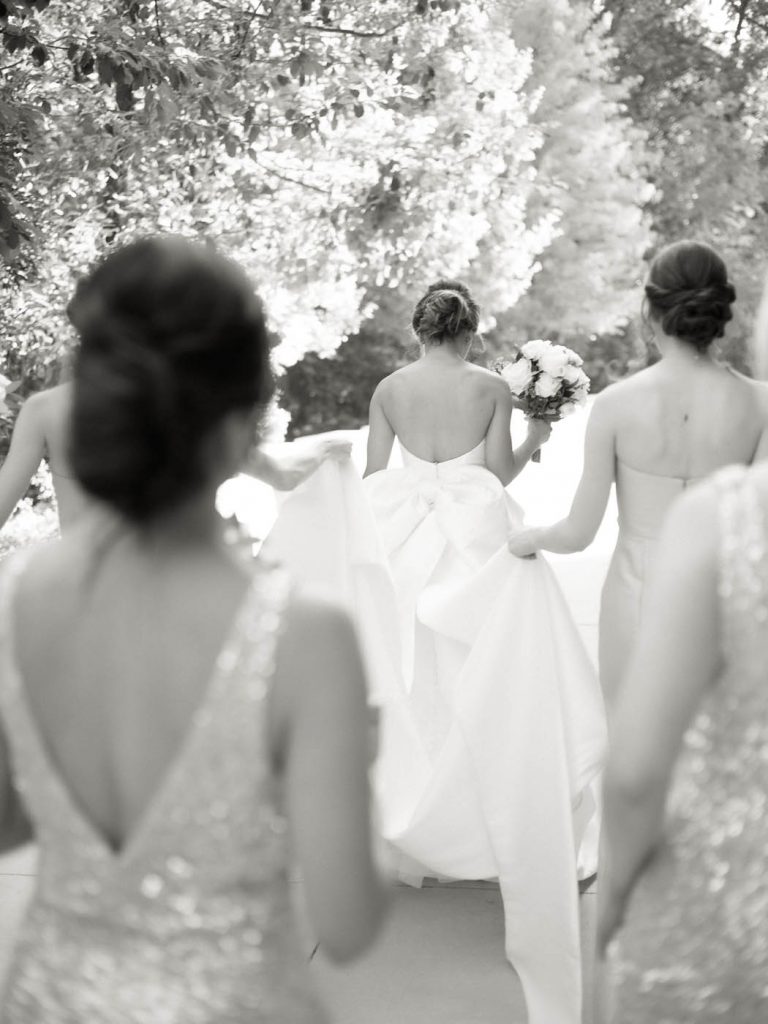 bridesmaids carry the bride's train