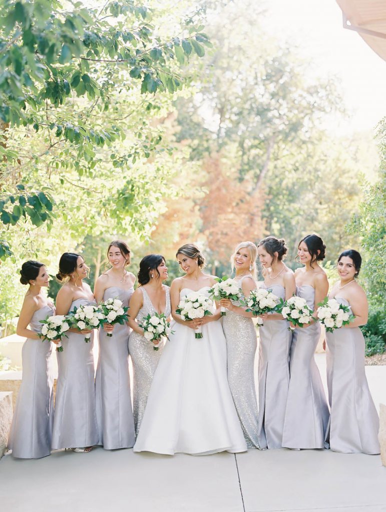 bridesmaids look at each other laughing and smiling