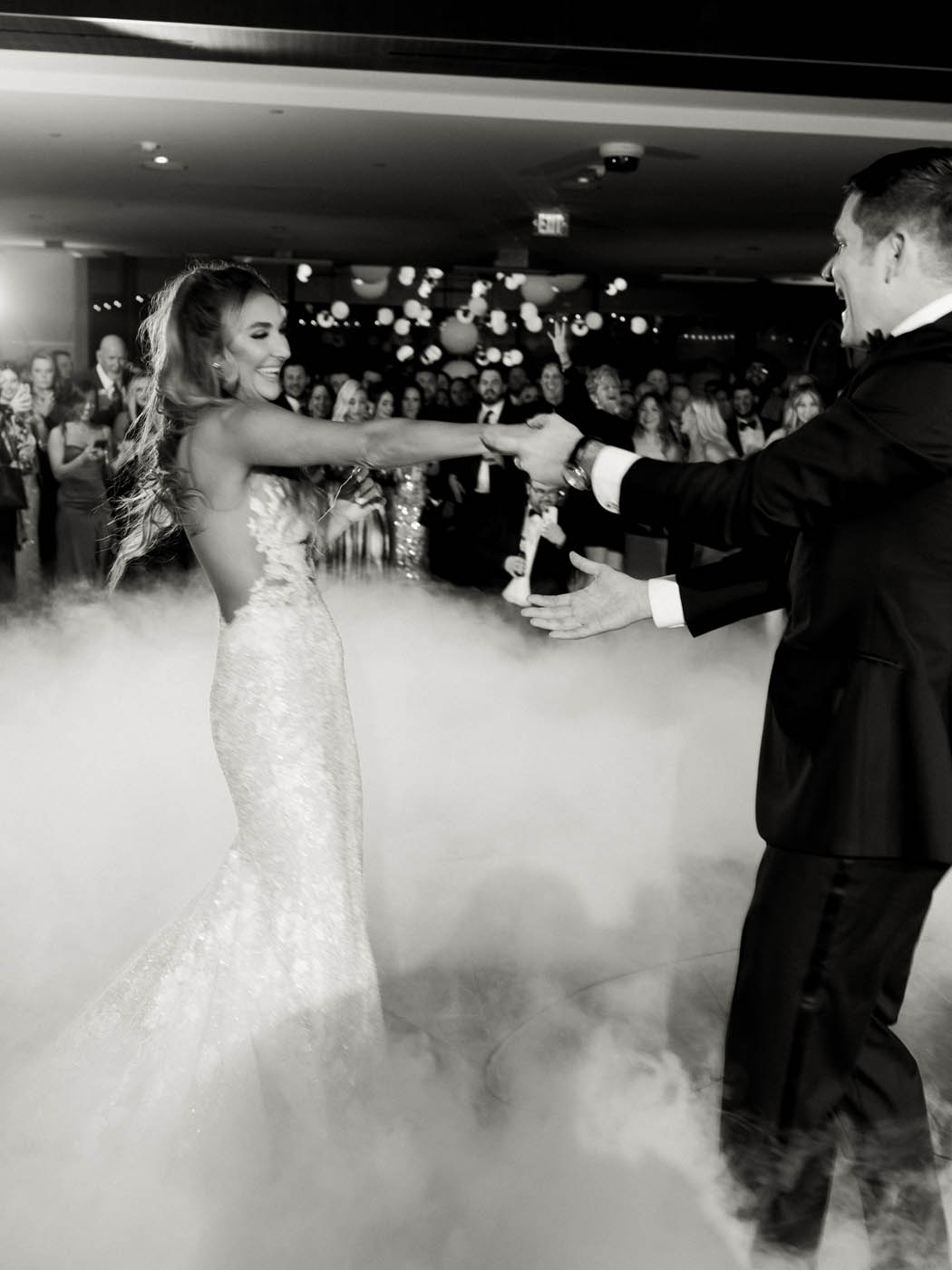 a candid black and white photo of the couple's first dance