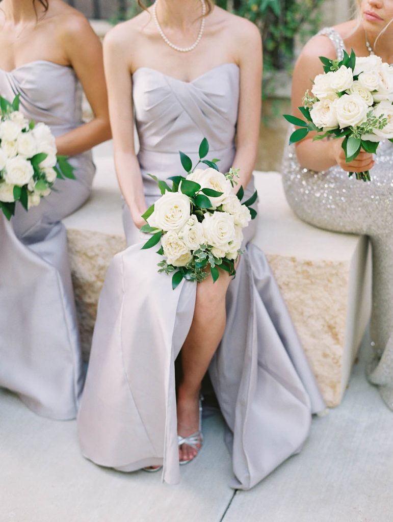 bridesmaids wait for their turn with bouquets in hand