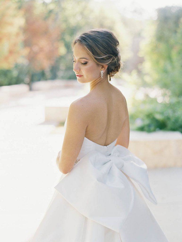 close up photo of the custom bow on the back of the bride's dress