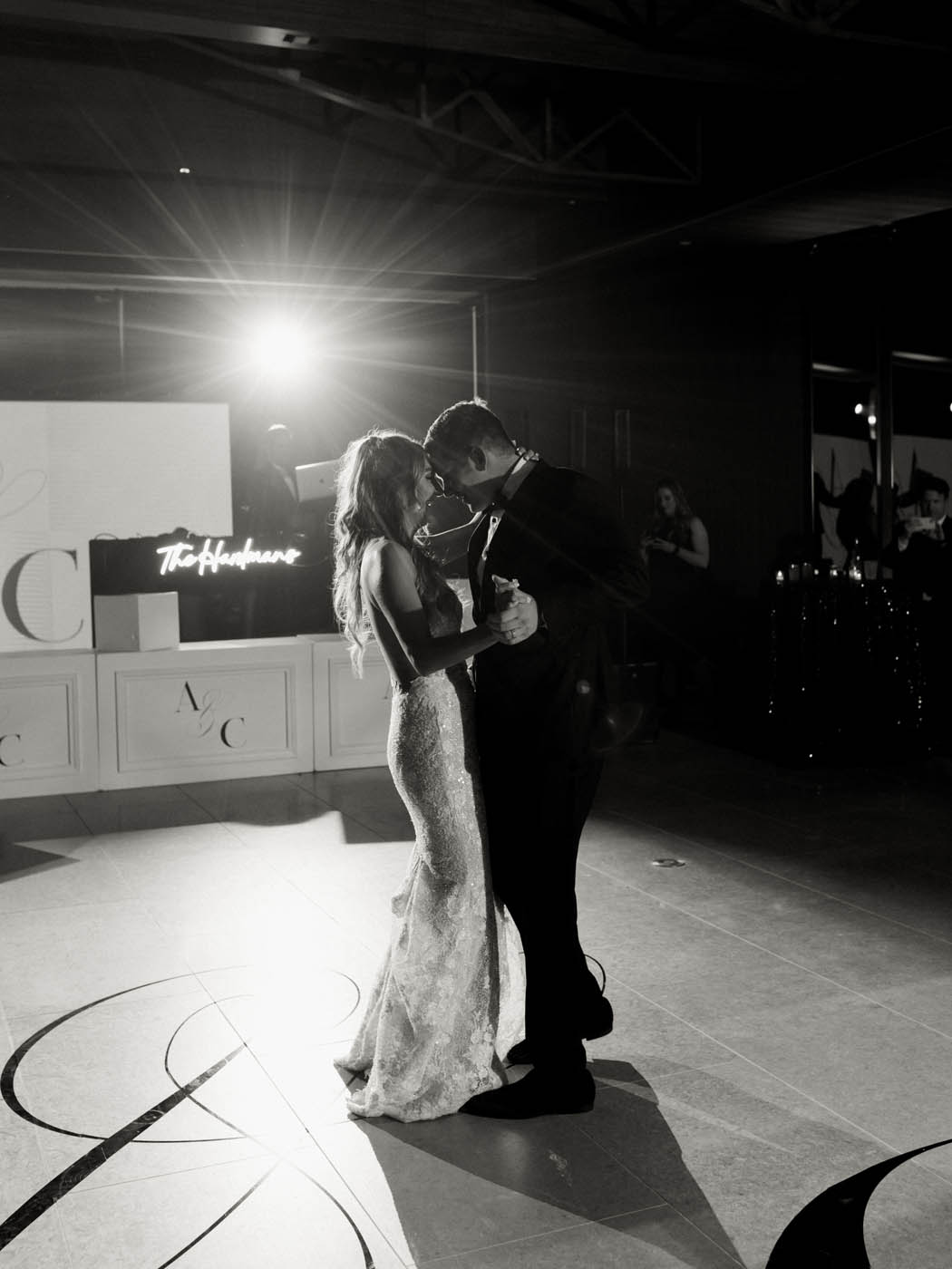 a dramatic black and white photo of the couple's first dance