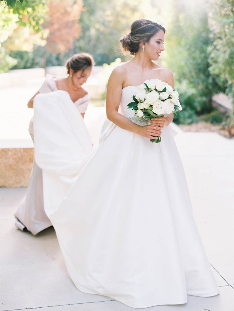 mom carries the bride's train