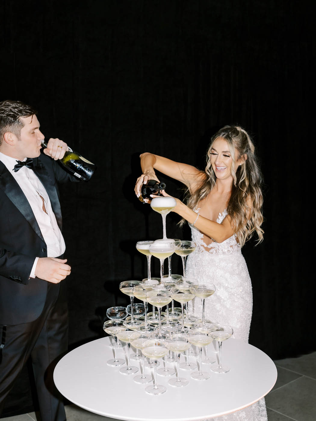 couple having fun during their champagne tower