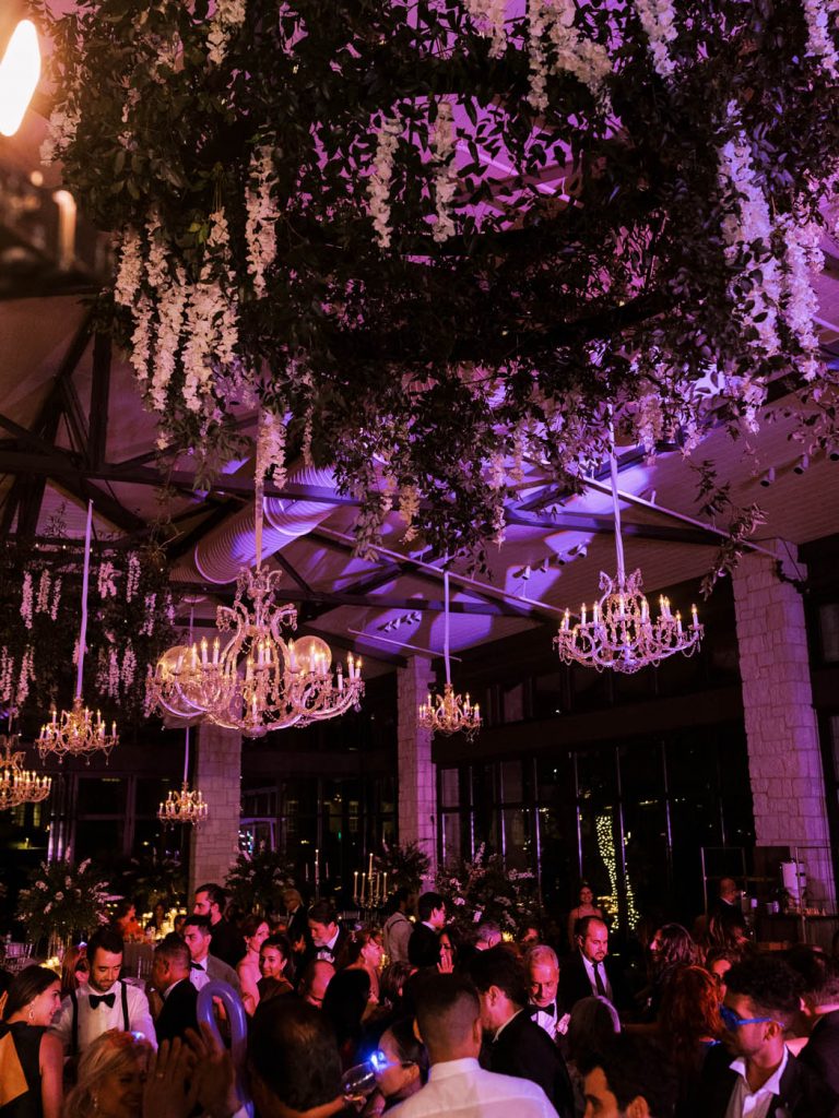 packed dance floor with purple uplighting