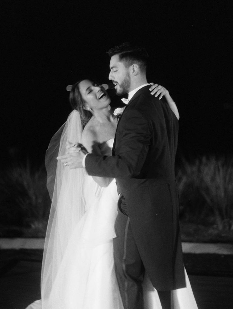 the bride and groom share their first dance and sing along to the song
