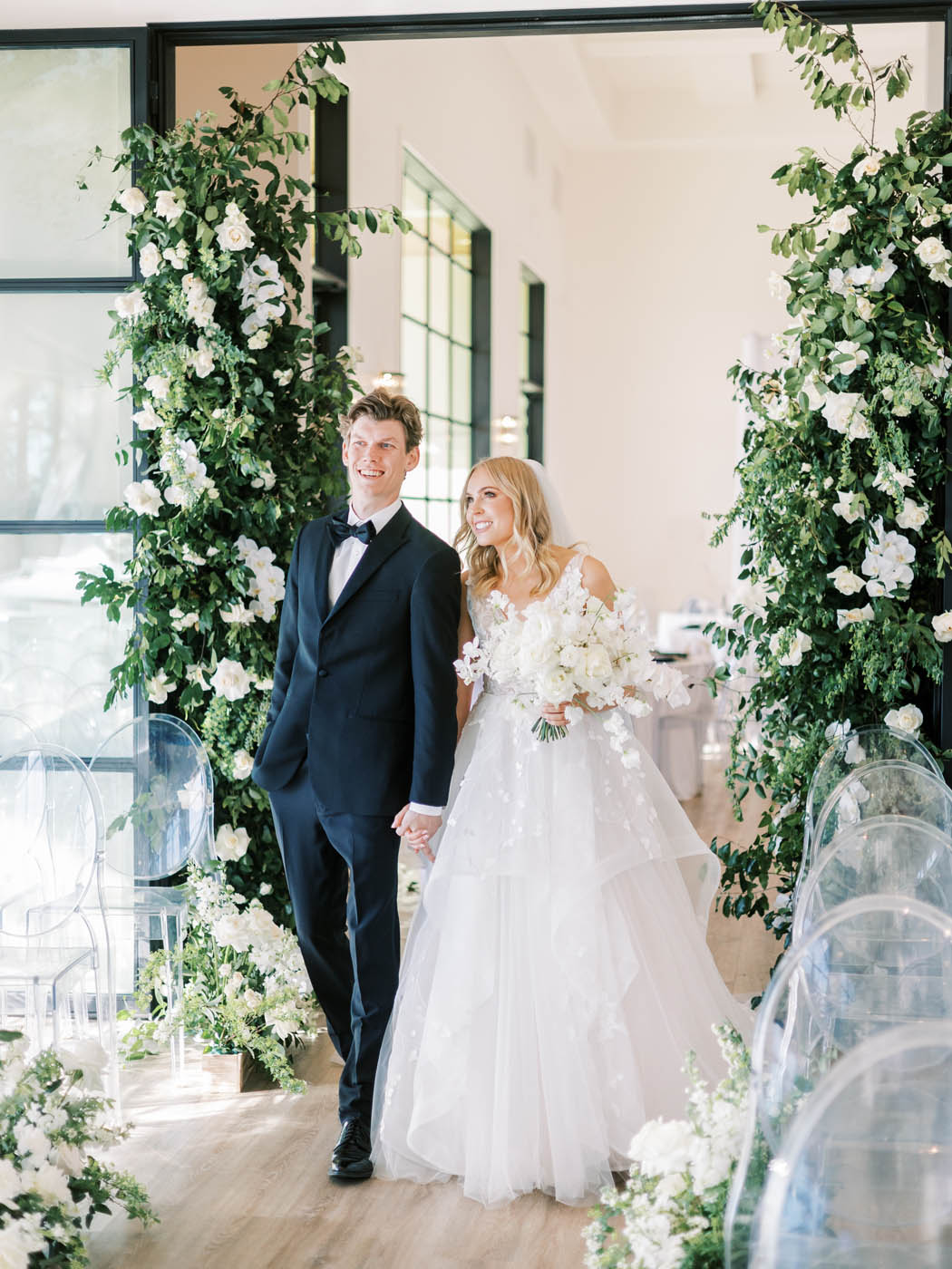 The bride and groom see their modern indoor garden wedding ceremony for the first time