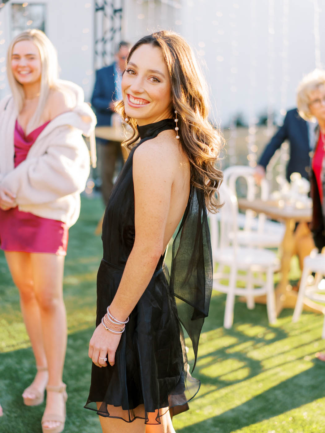 A portrait of a fashionable wedding guest at cocktail hour