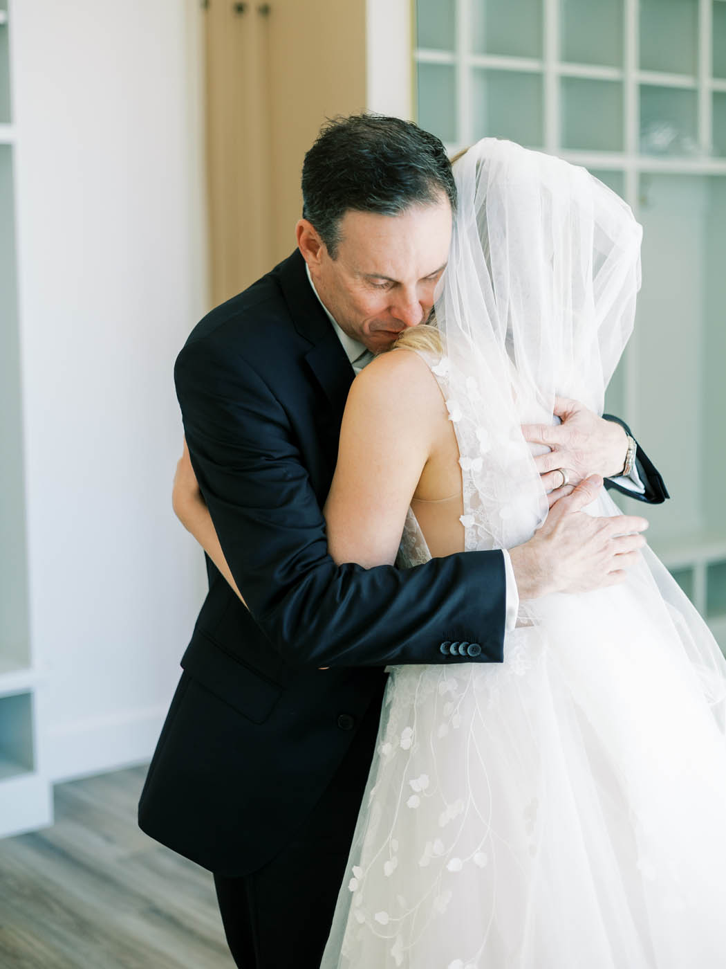 the bride and her father embrace as he sees her for the first time
