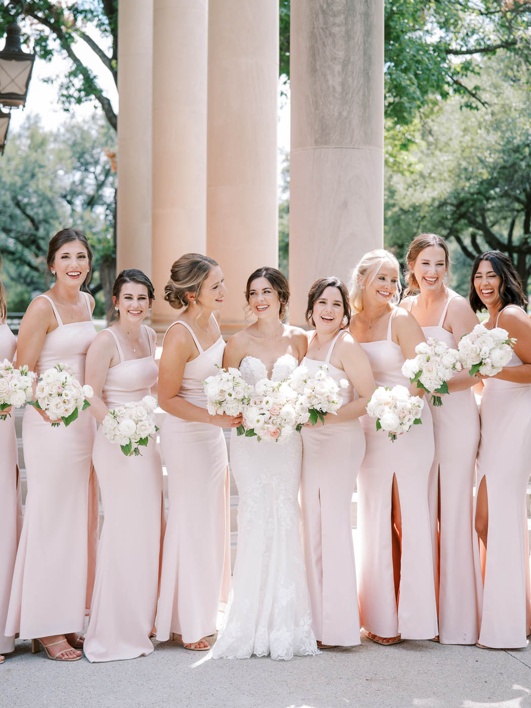 The bride and bridesmaids laugh together
