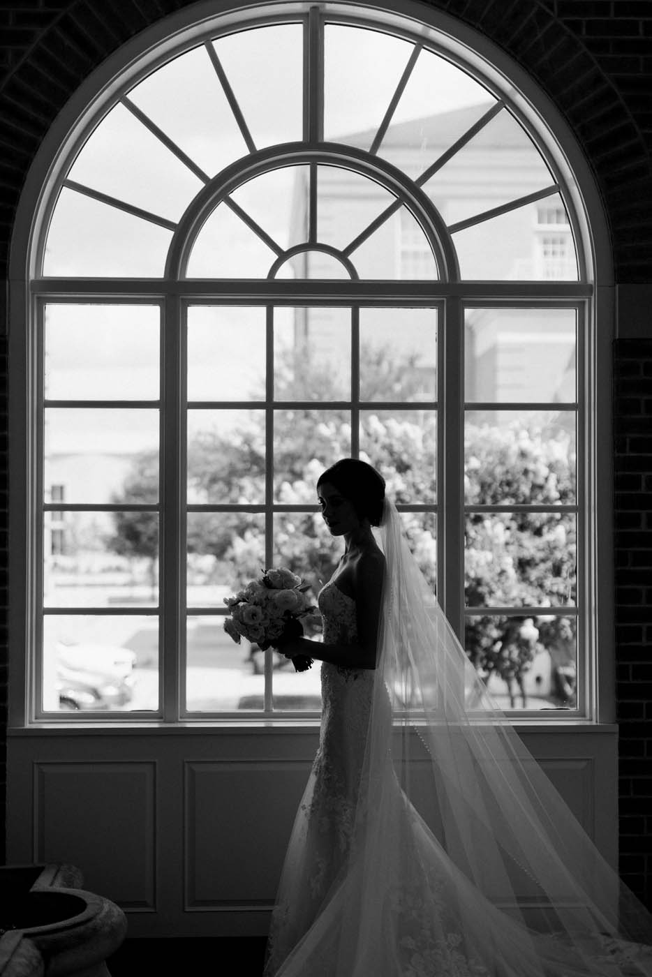 A dramatic photo of Nikki in front of a window at Robert Carr chapel