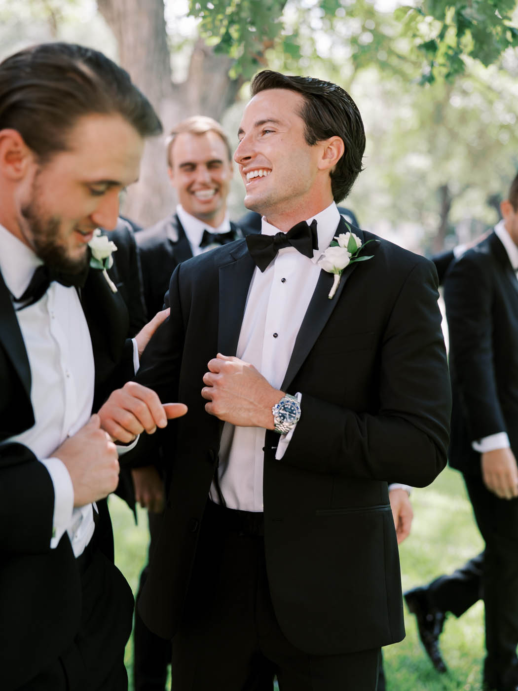 Ryan laughs with his groomsmen